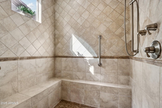 bathroom with a tile shower