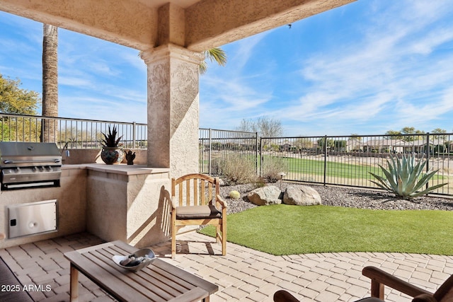 view of patio featuring an outdoor kitchen and area for grilling