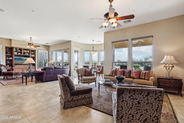 living room featuring light tile patterned floors and ceiling fan