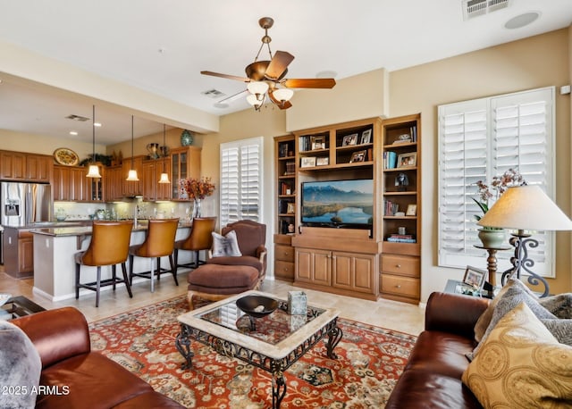 tiled living room featuring ceiling fan