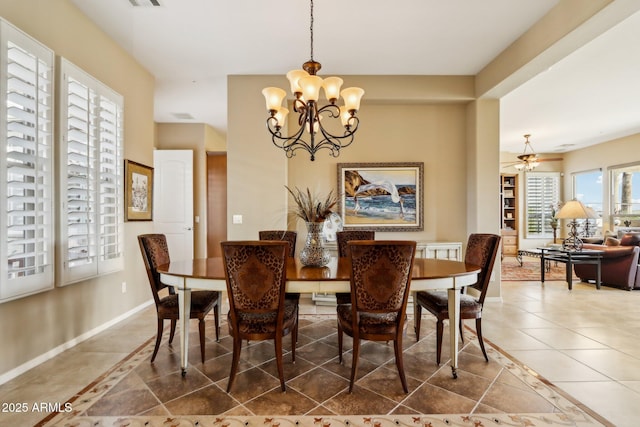 dining area featuring tile patterned floors and a chandelier