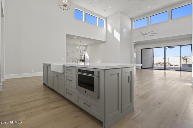 8503 S 9th Dr Unit 17, Phoenix, AZ 85041 - kitchen with gray cabinetry, a chandelier, open floor plan, and a high ceiling