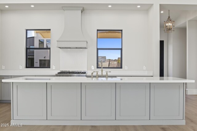 8503 S 9th Dr Unit 17, Phoenix, AZ 85041 - kitchen with premium range hood, a sink, light countertops, recessed lighting, and a kitchen island with sink