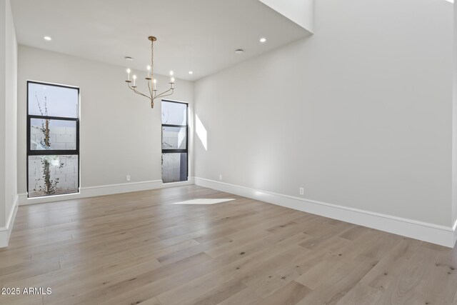 8503 S 9th Dr Unit 17, Phoenix, AZ 85041 - empty room with a chandelier, light wood-type flooring, baseboards, and recessed lighting