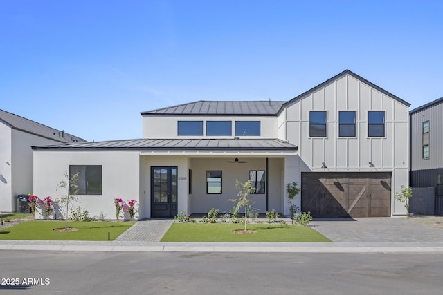 8503 S 9th Dr Unit 17, Phoenix, AZ 85041 - modern farmhouse featuring a standing seam roof, a garage, a front lawn, metal roof, and driveway