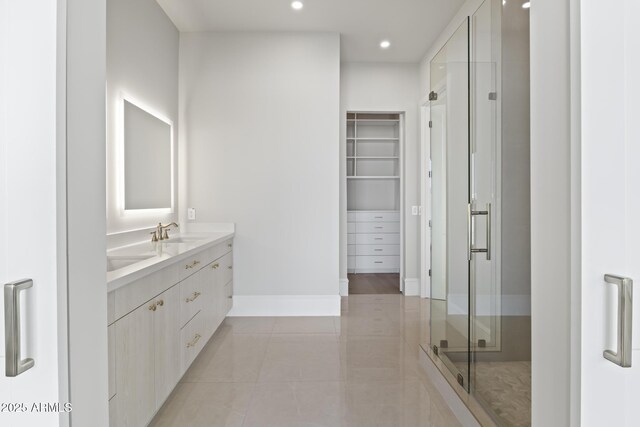 8503 S 9th Dr Unit 17, Phoenix, AZ 85041 - bathroom with a shower stall, tile patterned floors, vanity, a walk in closet, and recessed lighting