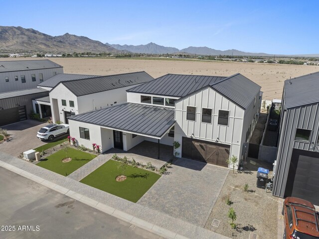 8503 S 9th Dr Unit 17, Phoenix, AZ 85041 - view of front of house with a standing seam roof, board and batten siding, a garage, metal roof, and driveway