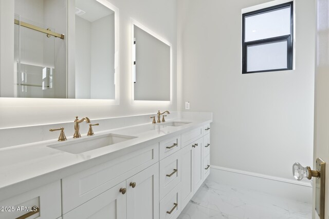 8503 S 9th Dr Unit 17, Phoenix, AZ 85041 - bathroom with marble finish floors, double vanity, baseboards, and a shower with shower door
