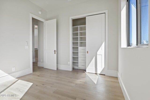 8503 S 9th Dr Unit 17, Phoenix, AZ 85041 - unfurnished bedroom featuring light wood-style floors, baseboards, and a closet