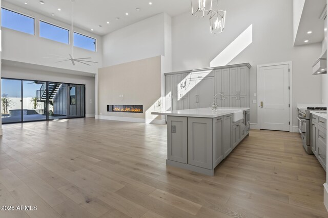 8503 S 9th Dr Unit 17, Phoenix, AZ 85041 - kitchen featuring gray cabinets, stainless steel range, a high ceiling, a sink, and open floor plan