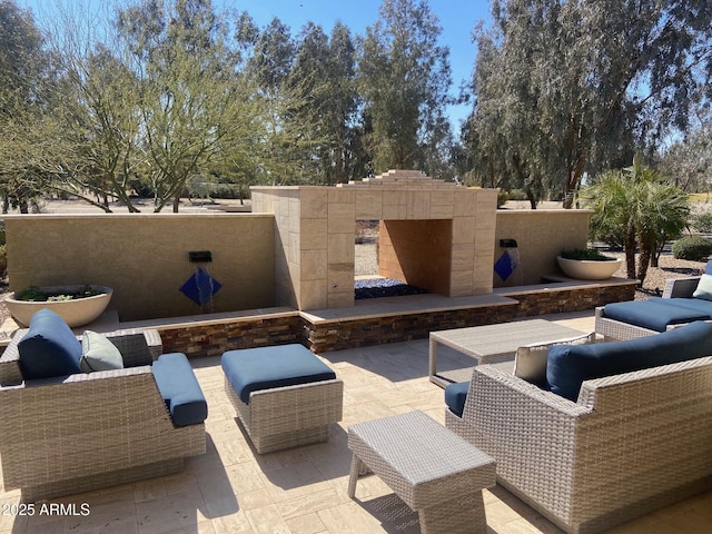 view of patio featuring an outdoor living space with a fireplace