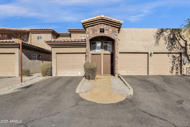 13700 N Fountain Hills Blvd Unit 151, Fountain Hills, AZ 85268 - view of front of property featuring a tile roof, stucco siding, a garage, and aphalt driveway