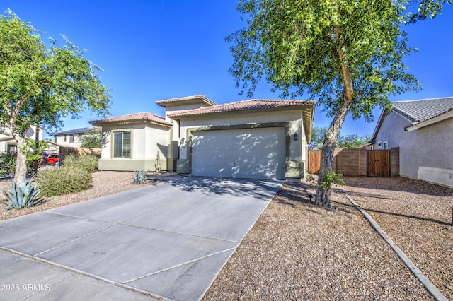 25659 W Forest Grove Ave, Buckeye, AZ 85326 - mediterranean / spanish-style home featuring a tiled roof, stucco siding, driveway, an attached garage, and a gate