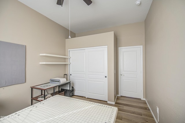 25659 W Forest Grove Ave, Buckeye, AZ 85326 - bedroom featuring wood finished floors, a closet, baseboards, and a ceiling fan