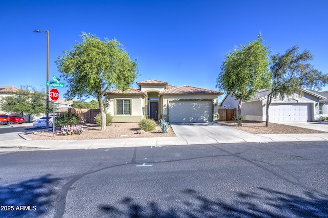 25659 W Forest Grove Ave, Buckeye, AZ 85326 - mediterranean / spanish house featuring concrete driveway, an attached garage, stucco siding, and a tile roof