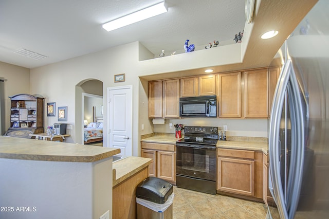25659 W Forest Grove Ave, Buckeye, AZ 85326 - kitchen featuring black appliances, arched walkways, light tile patterned floors, light countertops, and recessed lighting