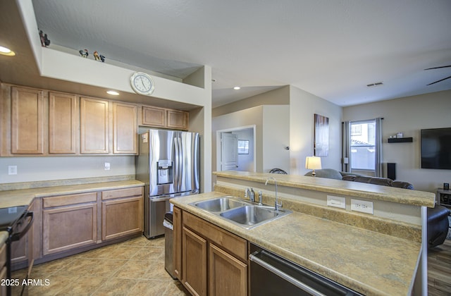 25659 W Forest Grove Ave, Buckeye, AZ 85326 - kitchen with appliances with stainless steel finishes, a sink, open floor plan, an island with sink, and light countertops