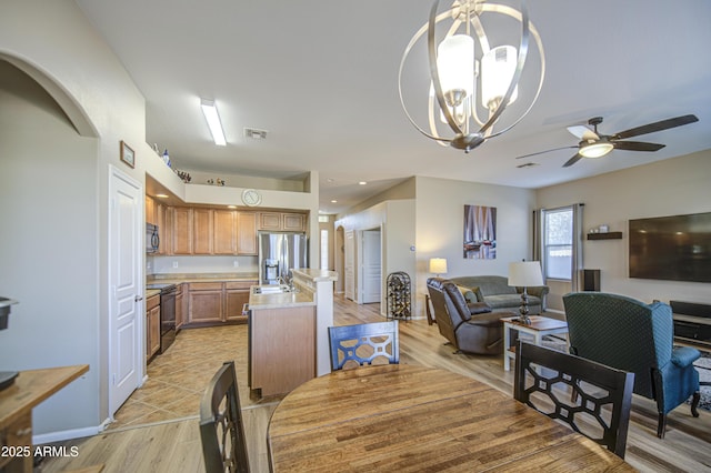 25659 W Forest Grove Ave, Buckeye, AZ 85326 - dining space with light wood-type flooring, ceiling fan, a chandelier, and baseboards