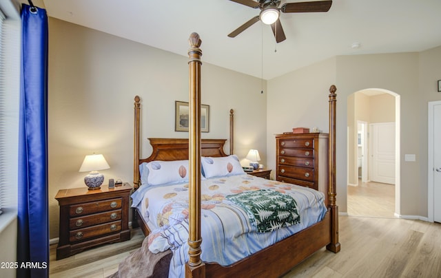 25659 W Forest Grove Ave, Buckeye, AZ 85326 - bedroom with arched walkways, light wood finished floors, a ceiling fan, and baseboards