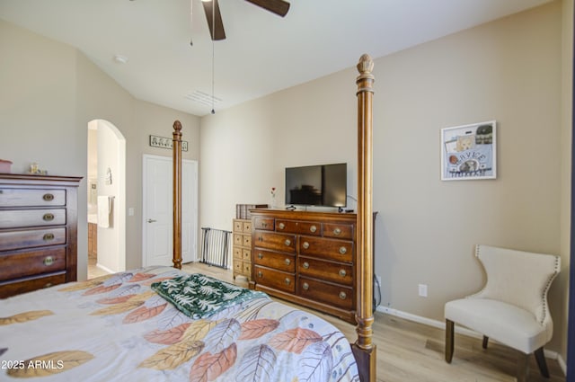25659 W Forest Grove Ave, Buckeye, AZ 85326 - bedroom featuring arched walkways, wood finished floors, baseboards, a ceiling fan, and ensuite bath