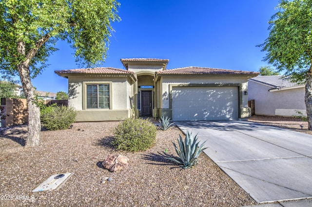 25659 W Forest Grove Ave, Buckeye, AZ 85326 - mediterranean / spanish house featuring an attached garage, stucco siding, driveway, and a tile roof
