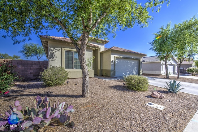 25659 W Forest Grove Ave, Buckeye, AZ 85326 - mediterranean / spanish house featuring concrete driveway, an attached garage, stucco siding, and a tile roof