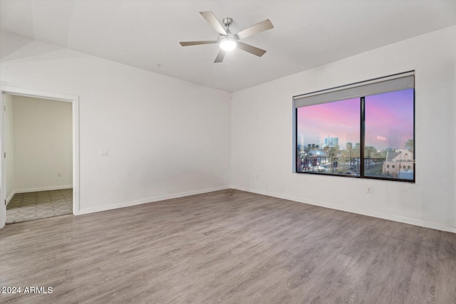 spare room with light wood-type flooring and ceiling fan