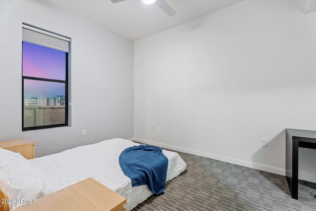 bedroom featuring multiple windows, dark colored carpet, and ceiling fan