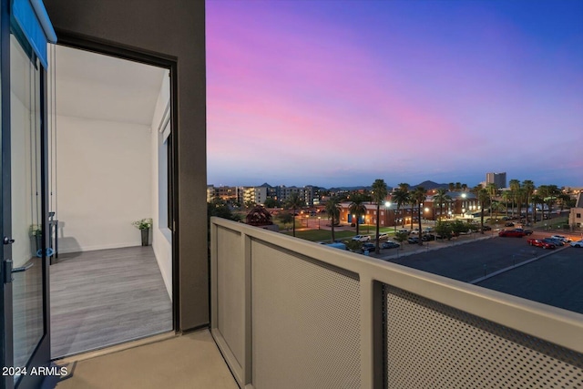 balcony at dusk with a view of city