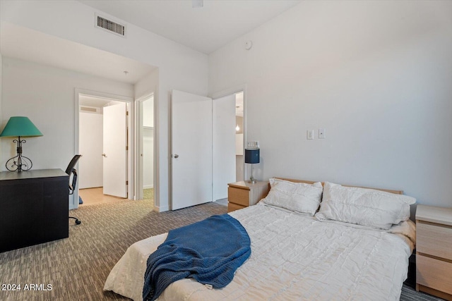 carpeted bedroom featuring visible vents