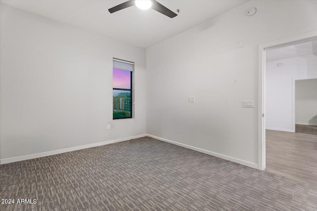 spare room featuring ceiling fan and carpet