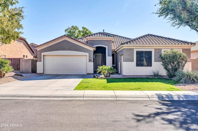 mediterranean / spanish-style house with a garage and a front yard