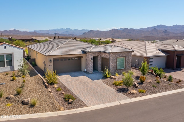 view of front of house with a garage and a mountain view