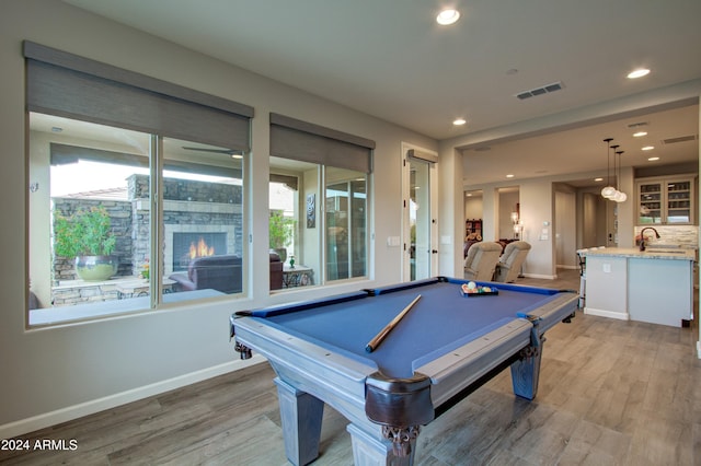 rec room featuring hardwood / wood-style flooring, sink, and pool table