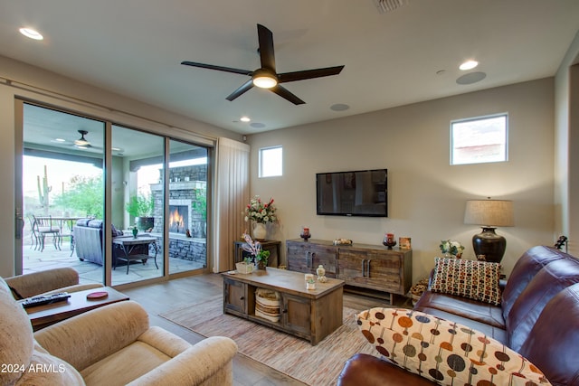 living room with light wood-type flooring and ceiling fan