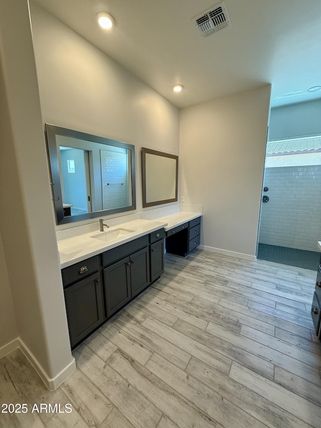 17324 W Royal Palm Rd, Waddell, AZ 85355 - bathroom featuring wood finished floors, a walk in shower, vanity, and recessed lighting
