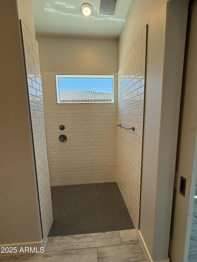 17324 W Royal Palm Rd, Waddell, AZ 85355 - bathroom with a tile shower and wood finished floors