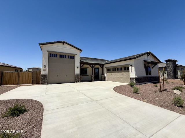 17324 W Royal Palm Rd, Waddell, AZ 85355 - view of front of house featuring stone siding, an attached garage, and driveway