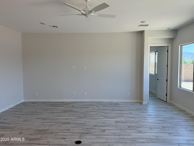17324 W Royal Palm Rd, Waddell, AZ 85355 - unfurnished room featuring a ceiling fan, light wood finished floors, and baseboards