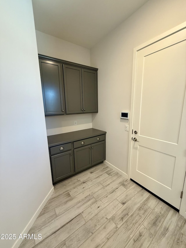 17324 W Royal Palm Rd, Waddell, AZ 85355 - laundry area featuring light wood-style floors and baseboards