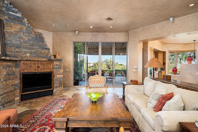 living room with a stone fireplace