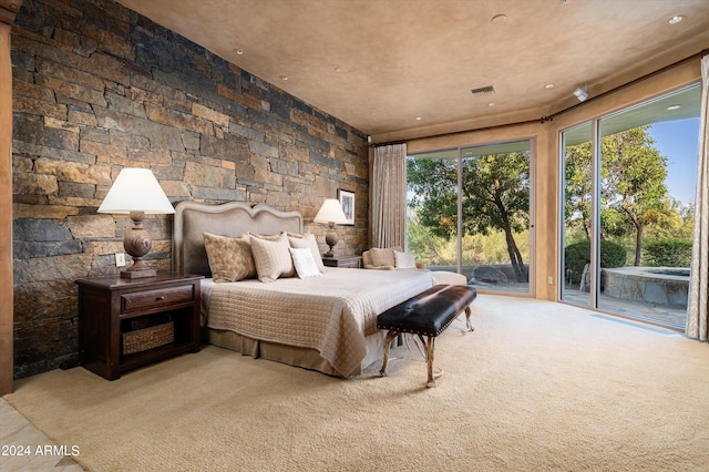 carpeted bedroom with access to outside