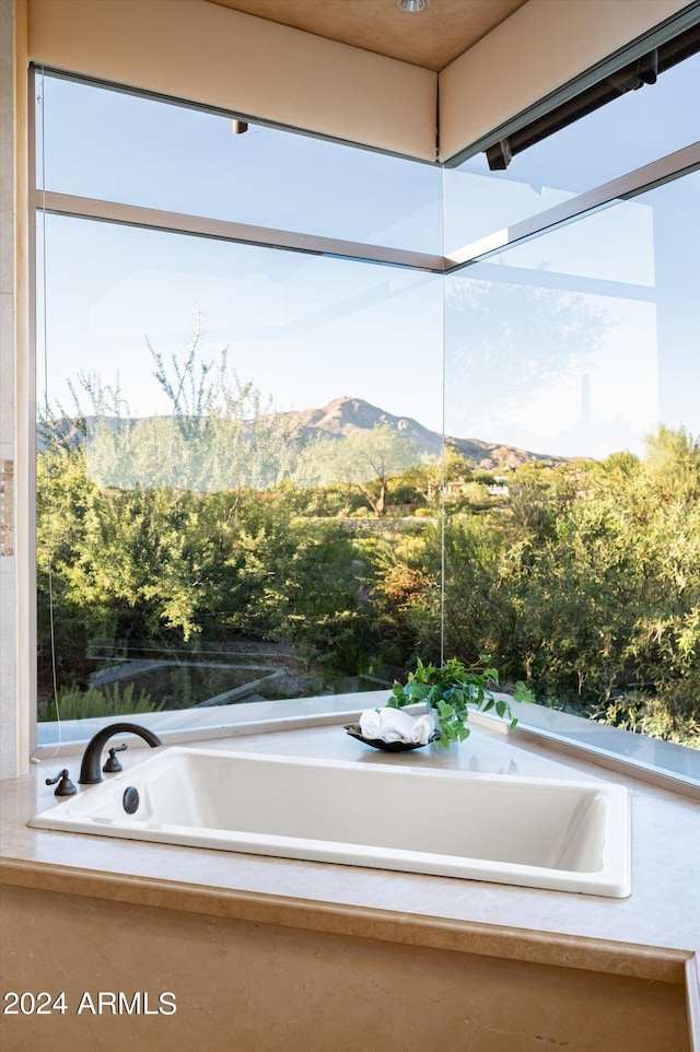 interior space with a mountain view and a relaxing tiled tub