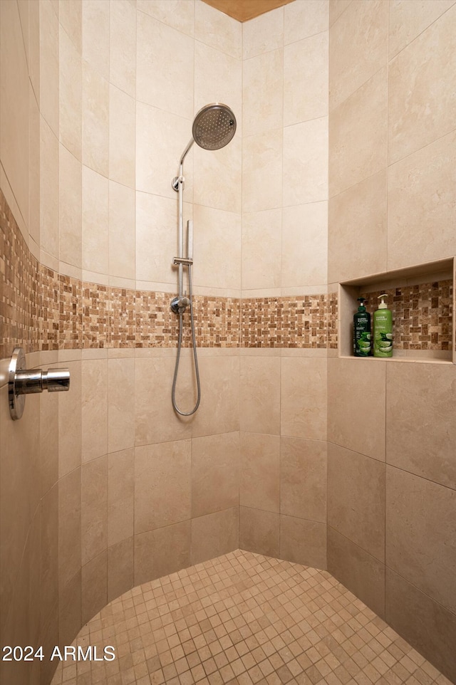 bathroom with a tile shower