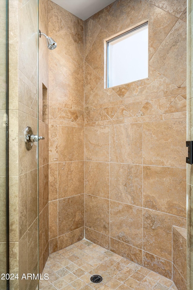 bathroom featuring a shower with shower door