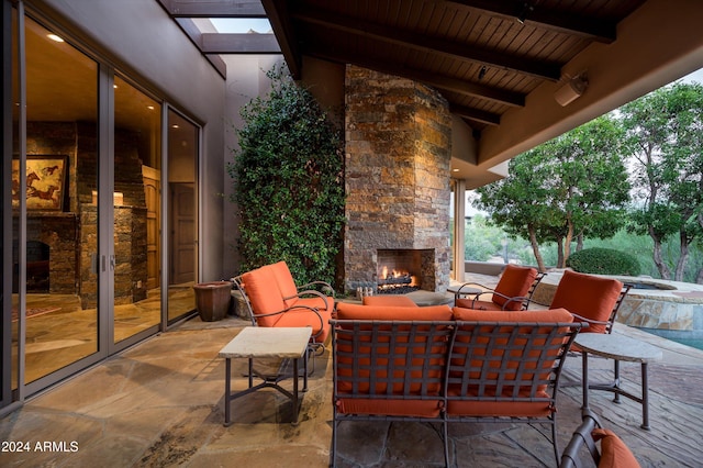 view of patio with an outdoor living space with a fireplace and a pool