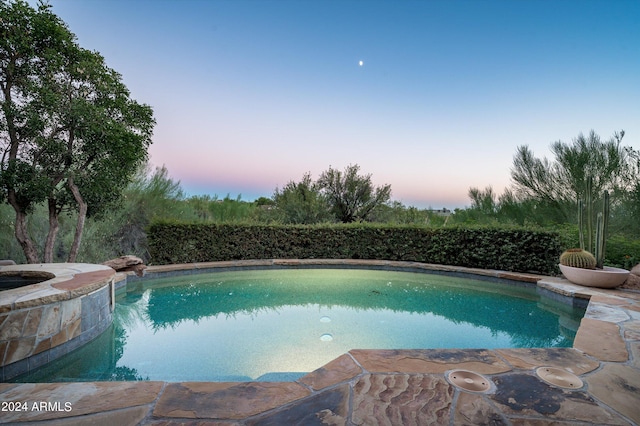 view of pool at dusk