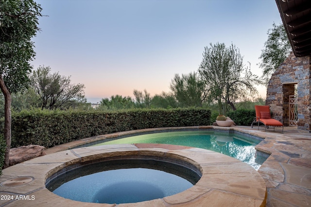 view of pool with an in ground hot tub and a patio area