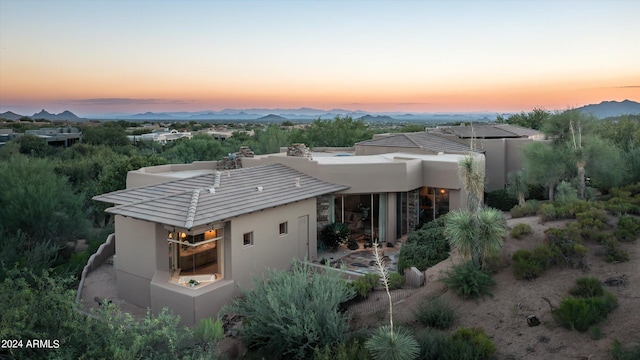 back house at dusk featuring a mountain view