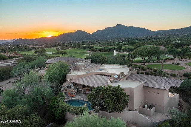 aerial view at dusk featuring a mountain view